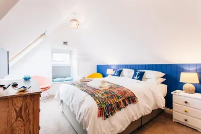 a bedroom with a large bed and a desk at No4 St Ives in St Ives