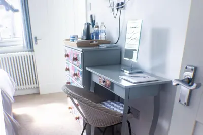 a blue desk with a mirror and a drawer at No4 St Ives in St Ives