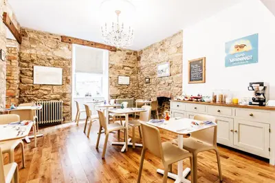 a restaurant with tables and chairs in a room at No4 St Ives in St Ives