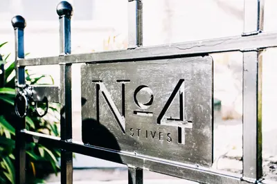 a sign that says noaa sits on a gate at No4 St Ives in St Ives