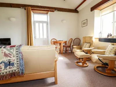 a living room with a couch and chairs and a table at Wheal Kitty in Newlyn East