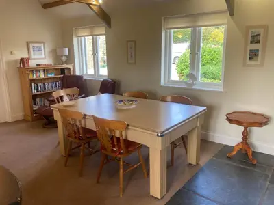 a dining room with a wooden table and chairs at Wheal Hart in Newlyn East