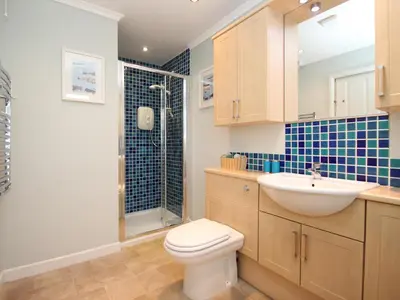 a bathroom with a toilet and a sink and a shower at An Kres in Mevagissey