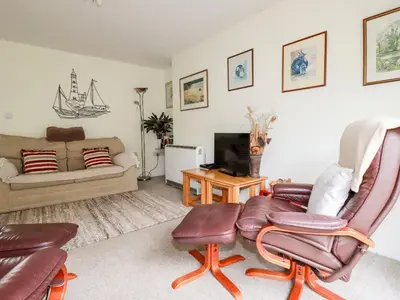 a living room with a couch and a chair at An Kres in Mevagissey