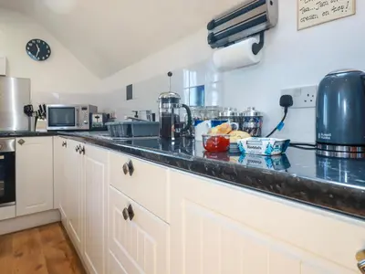 a kitchen with white cabinets and a counter top at Sunnyvale in Bugle