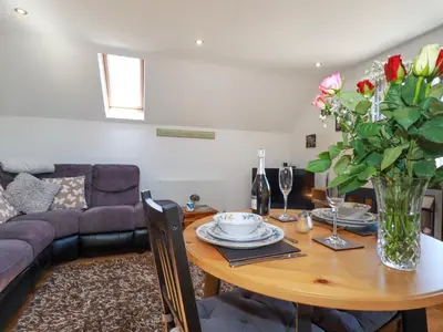 a living room with a table with a vase of flowers at Sunnyvale in Bugle