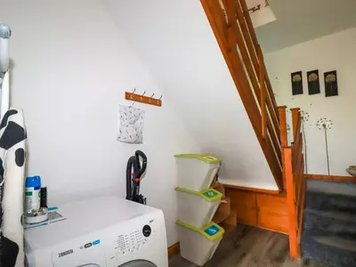 a laundry room with a washing machine and a staircase at Sunnyvale in Bugle