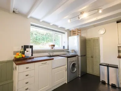 a kitchen with a sink and a dishwasher at 5 Bodmin Hill in Lostwithiel