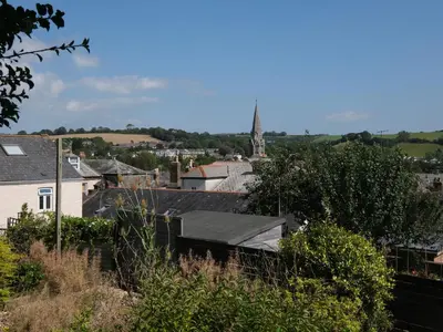 a view of a town with a tower in the distance at 5 Bodmin Hill in Lostwithiel