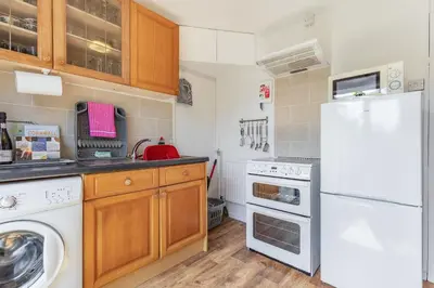 a kitchen with a white refrigerator and a dishwasher at Yazumez in Bugle