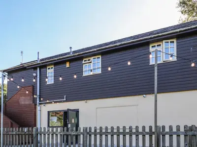 a black and white building with a fence at The Station Flat in Newlyn East