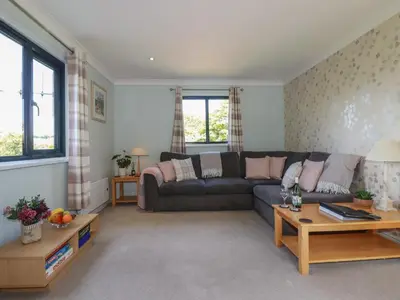 a living room with a couch and a table at The Station Flat in Newlyn East