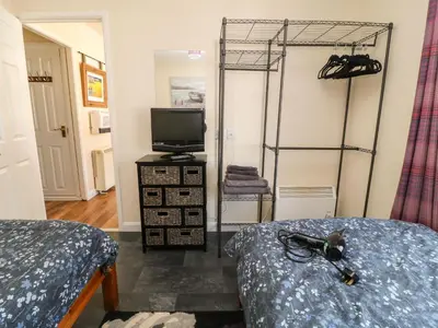 a bedroom with two beds and a tv in it at 3 Rosecraddoc Lodge in Saint Cleer