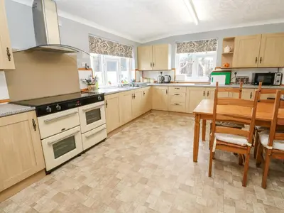 a kitchen with a table and a dining room at Trelydarth in St. Agnes