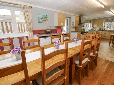 a kitchen and dining room with a table and chairs at Trelydarth in St. Agnes