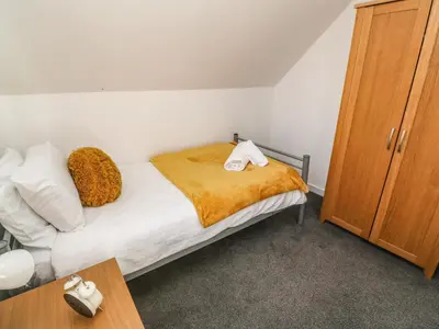 a bedroom with a bed with two towels on it at Two Threes in Saint Hilary