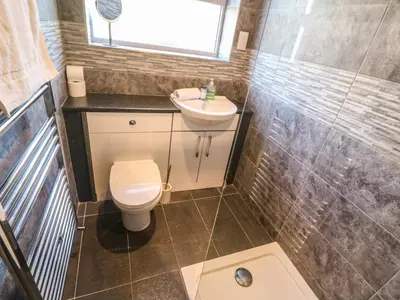 a small bathroom with a toilet and a sink at Two Threes in Saint Hilary