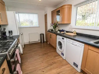 a kitchen with a washer and dryer at Two Threes in Saint Hilary