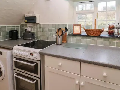 a kitchen with a stove and a counter top at Honeycrock in Cubert