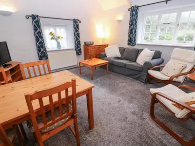 a living room with a couch and a table at Honeycrock in Cubert