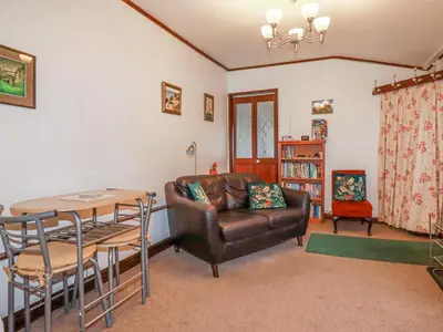 a living room with a couch and a table at The Annexe, Laburnum in Bugle