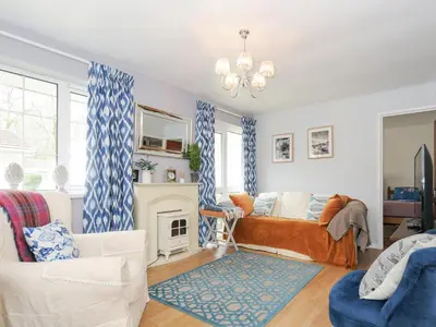 a living room with a bed and a fireplace at No 1 The Heathers in Saint Cleer