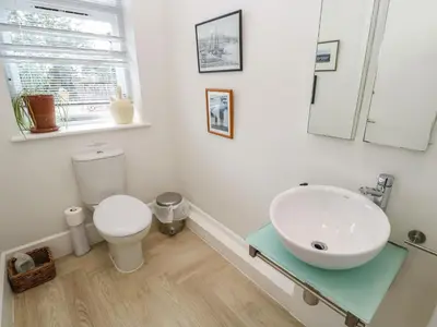 a bathroom with a sink and a toilet at Penarvon House in Helford
