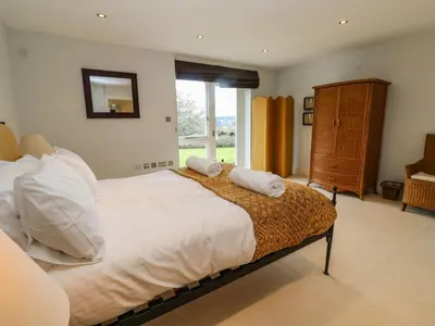 a bedroom with a bed with two towels on it at Penarvon House in Helford