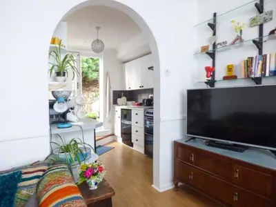 a living room with a couch and a large television at Tidewood in Polzeath