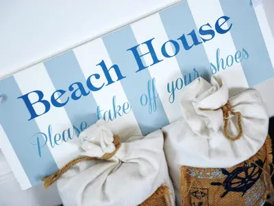 a sign for a beach house with towels at The Blue House in Tintagel