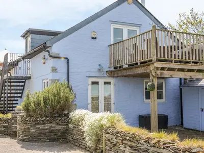a blue house with a deck on top of it at The Blue House in Tintagel
