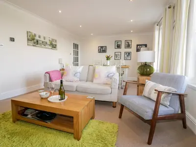 a living room with a couch and a table at Tremanners in St. Agnes