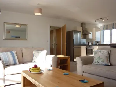 a living room with a couch and a table at 28 Clock Tower Court in Charlestown
