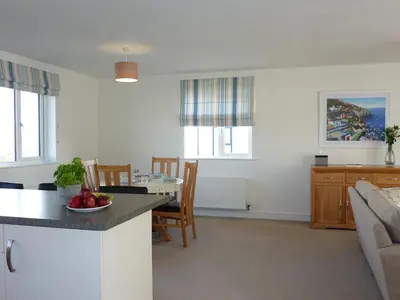 a kitchen and living room with a table and a couch at 28 Clock Tower Court in Charlestown