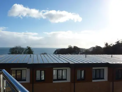 a building with solar panels on the roof at 28 Clock Tower Court in Charlestown