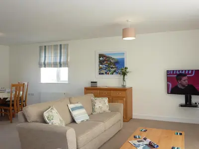 a living room with a couch and a table at 28 Clock Tower Court in Charlestown