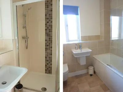 a bathroom with a shower and a sink and a toilet at 28 Clock Tower Court in Charlestown