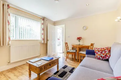 a living room with a couch and a table at 19 Cormorant Drive The Annexe in St Austell