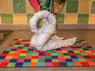 a towel with a towel snake on a rug at Tiggy Winkle in St Merryn
