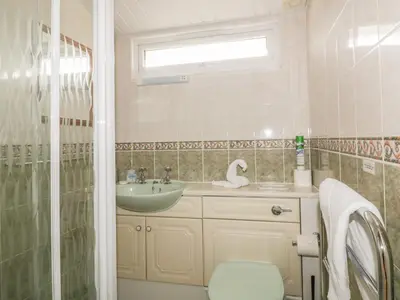 a bathroom with a sink and a toilet and a shower at Tiggy Winkle in St Merryn