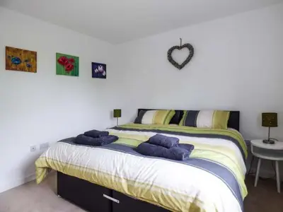 a bedroom with a large bed with purple pillows at Tehidy in Charlestown