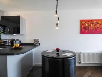 a kitchen with a black island in a room at Tehidy in Charlestown