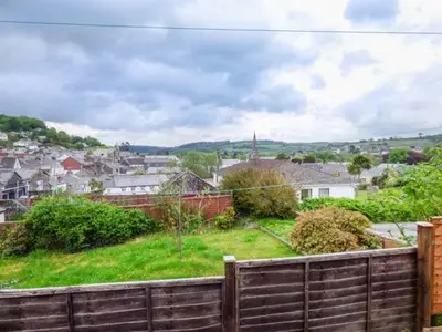 a view of a town from behind a wooden fence at 13 Castle Hill in Lostwithiel