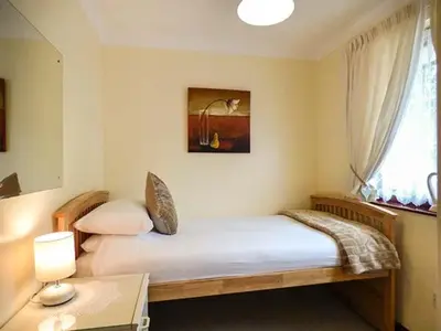 a bedroom with a bed and a window at Chy Lowenna in Saint Cleer