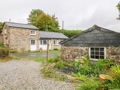 an old stone house and a stone cottage at Treverbyn Smithy in Saint Neot