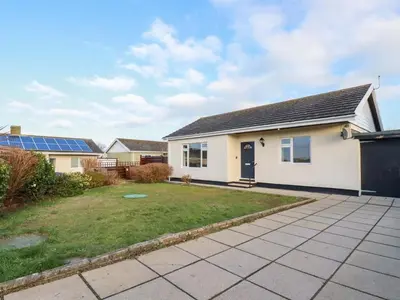 a house with solar panels in a yard at Merlin's Retreat in Tintagel