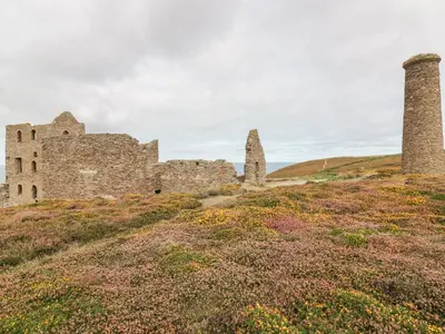an old castle on a hill with two towers at Apartment 1, Trearren in St. Agnes