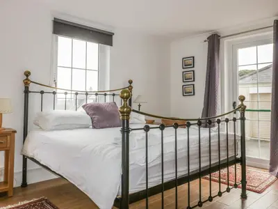 a bedroom with a bed and a window at Apartment 1, Trearren in St. Agnes