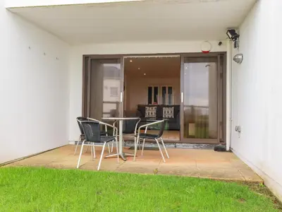 a patio with chairs and a table in a house at 47 Bredon Court in Newquay