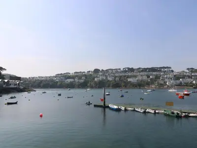 a group of boats in a large body of water at The Watch Below in Polruan